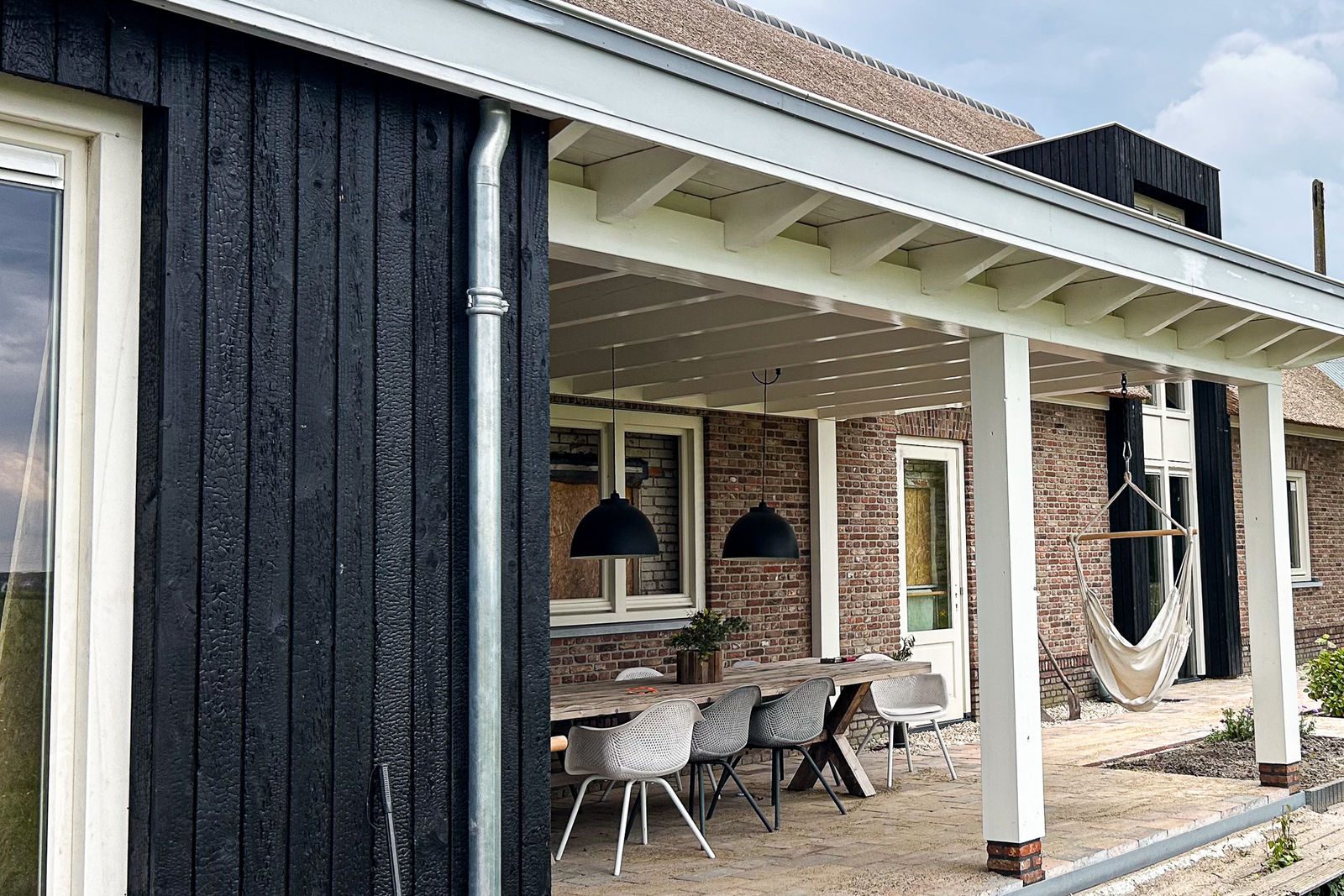 Covered terrace with charred wood cladding